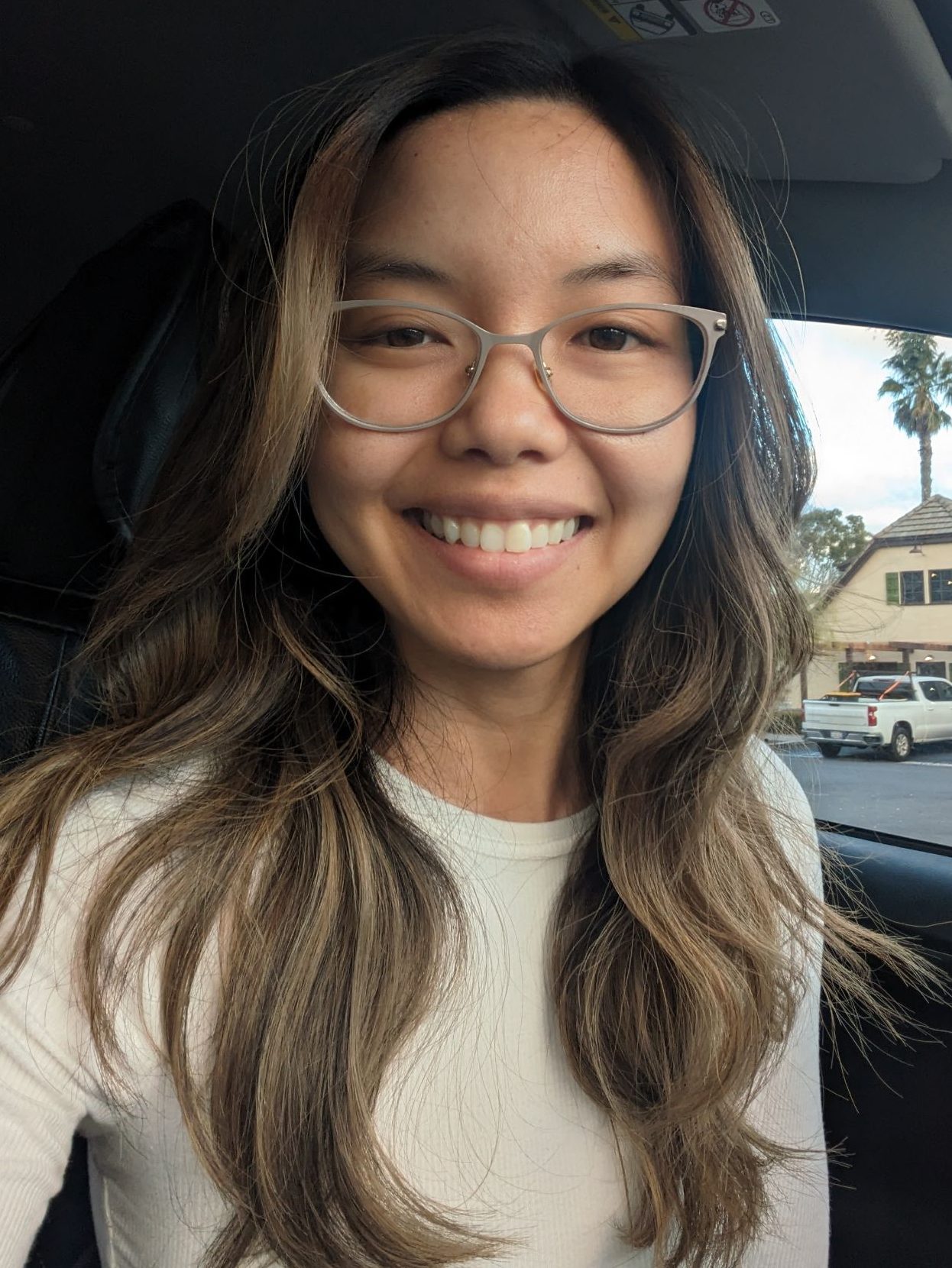 An Asian woman sitting in a car